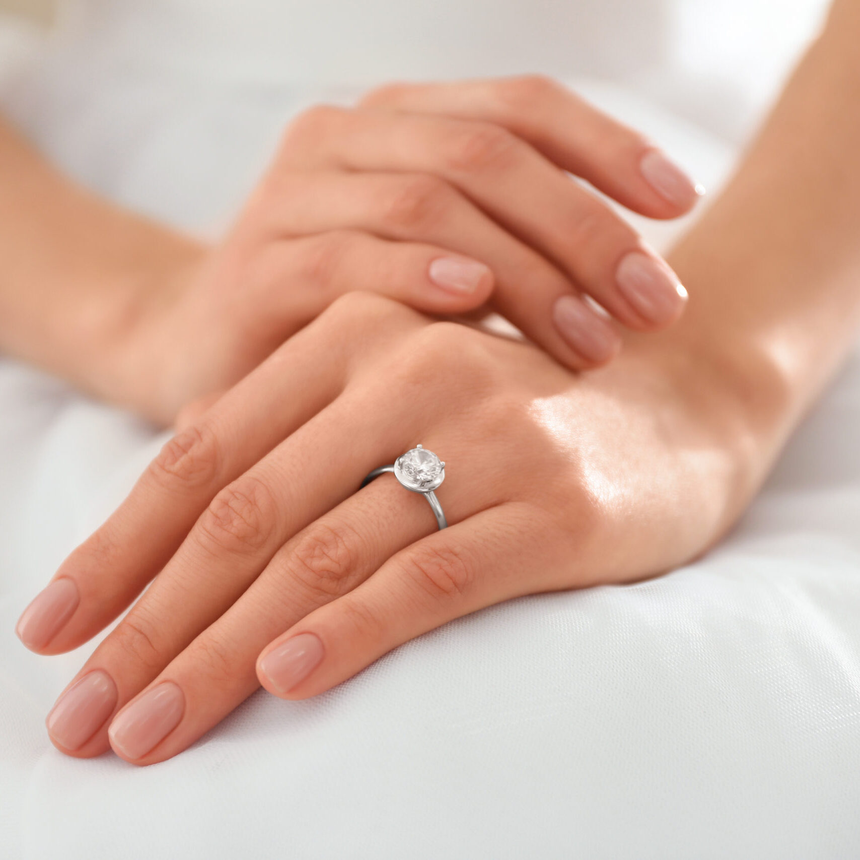 Young bride wearing beautiful engagement ring, closeup